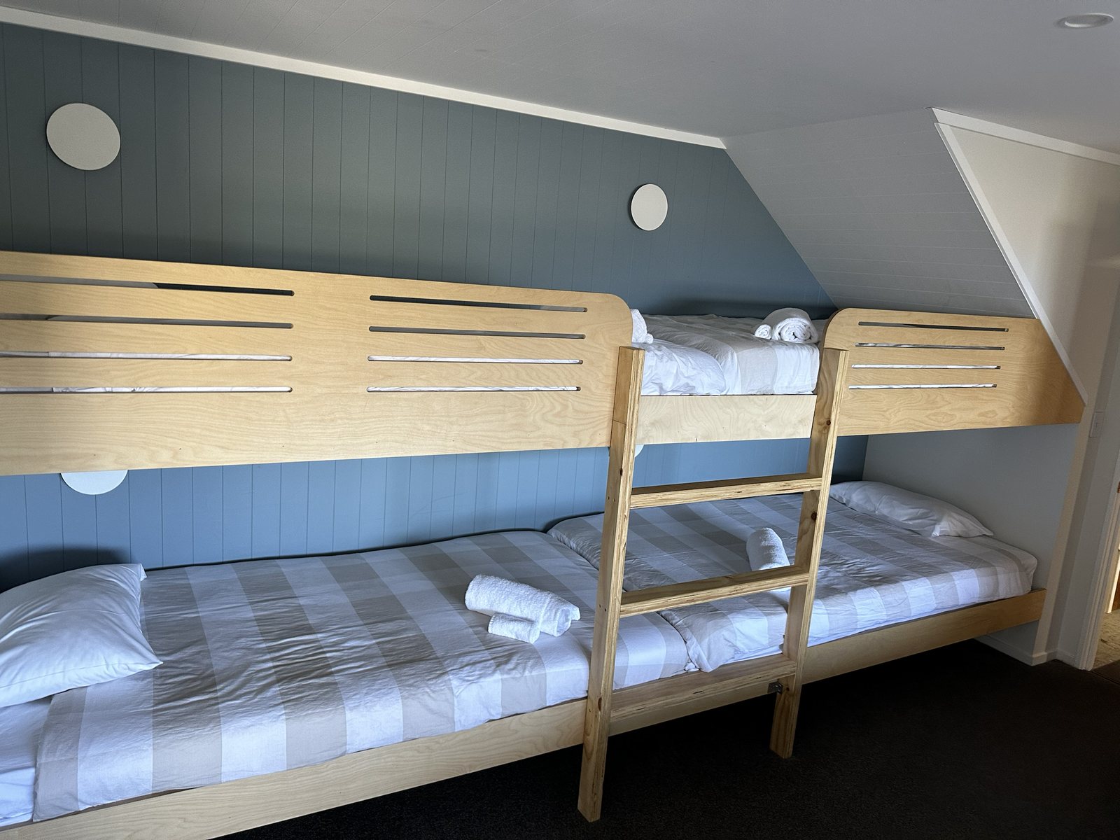 Wooden bunk beds with folded towels