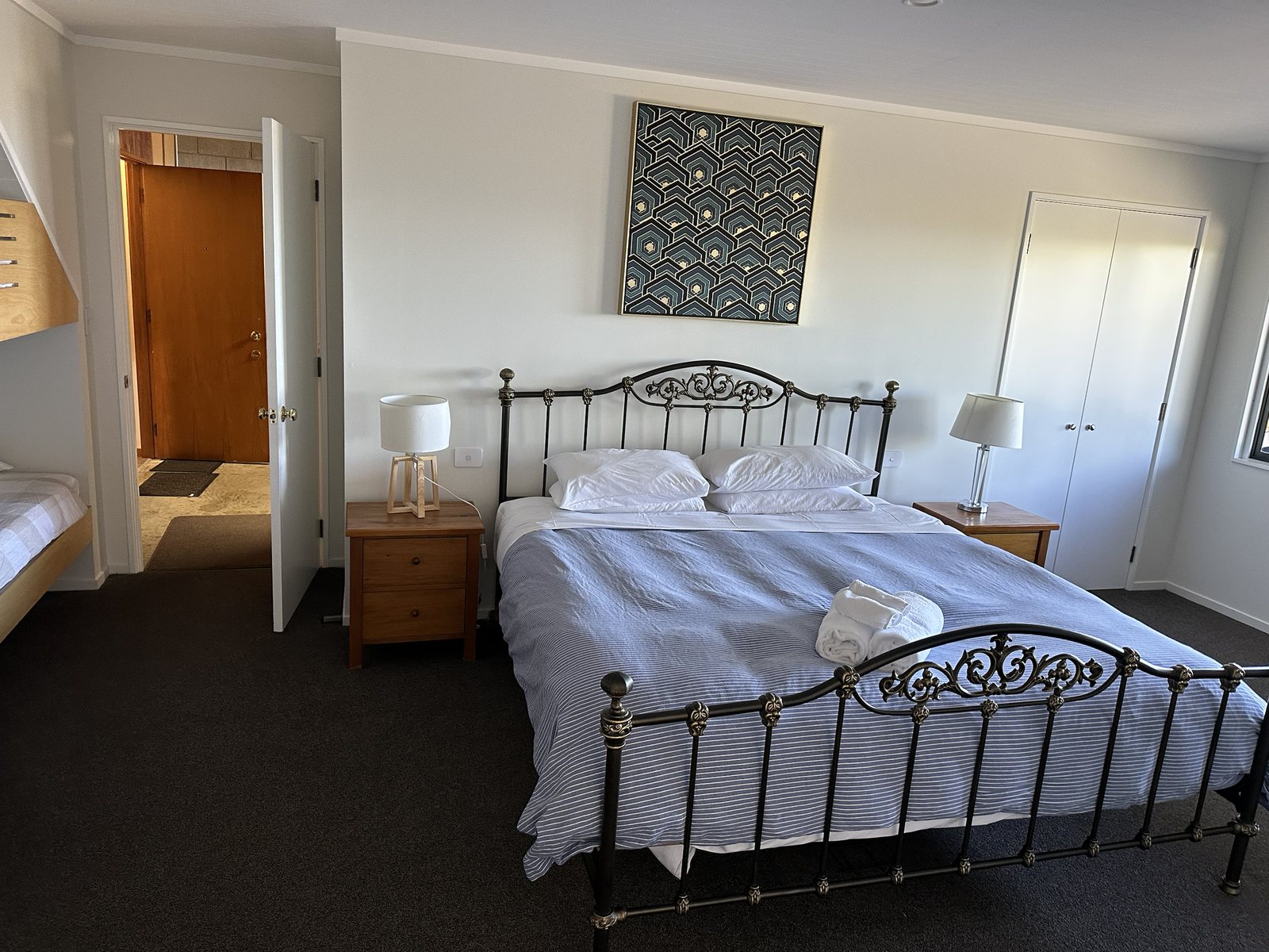 King bedroom with white bedding and bedside tables