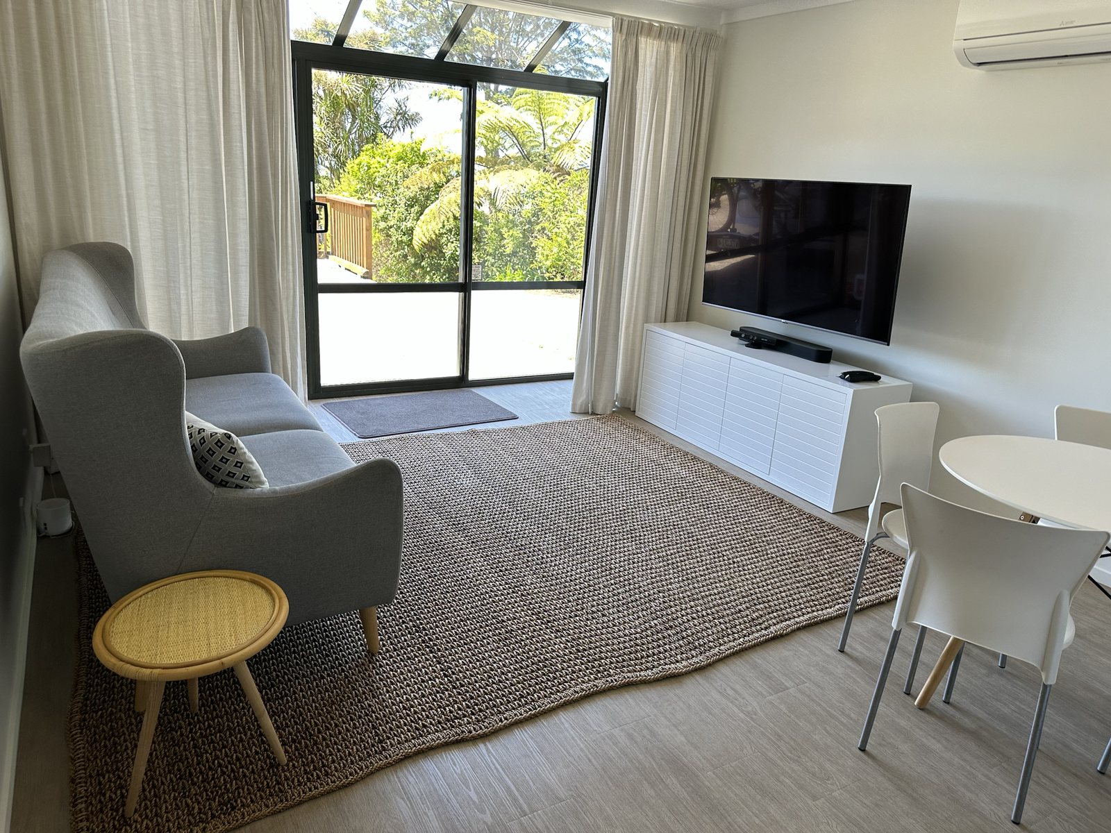 Movie room with armchair, television, and sliding door