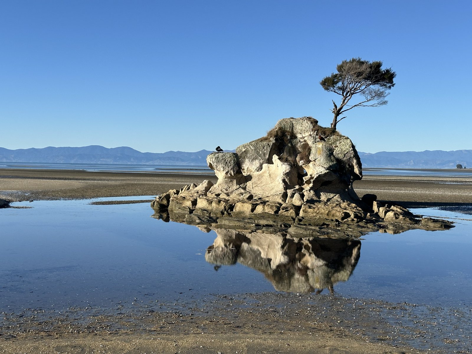 Split Apple Rock reflected in still water